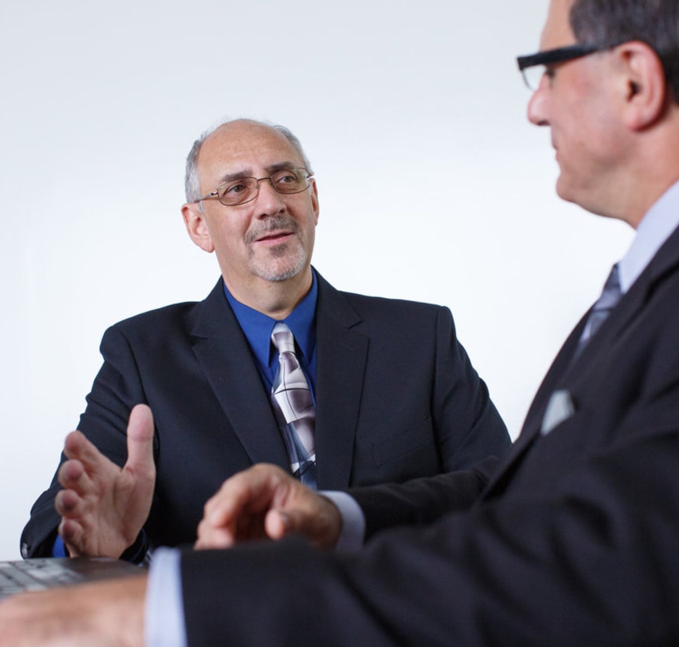 Men at table discussing