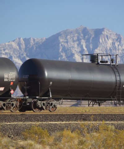 Tank cars passing a mountain range